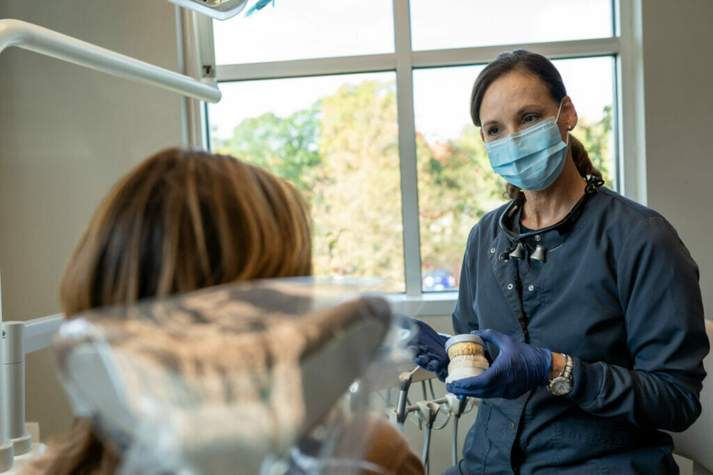 dental assistant advising patient