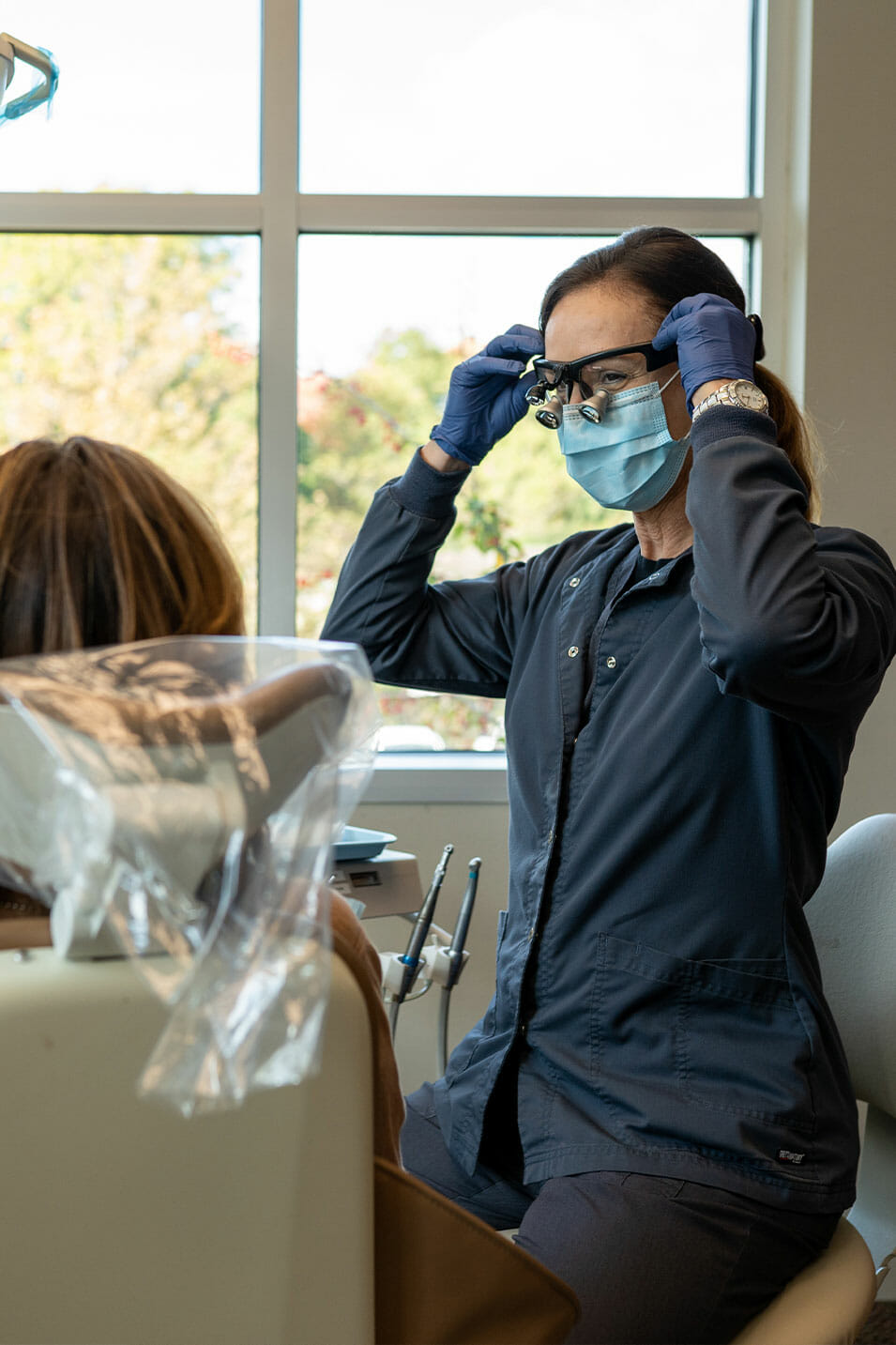 putting on dental equipment to do dental exam